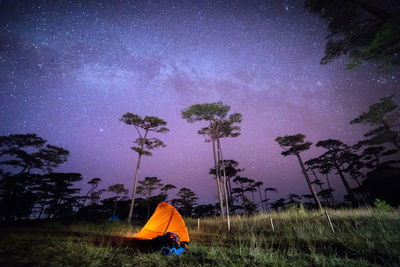 Scenic view of tent against star field at night