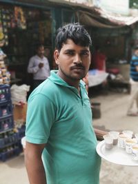 Portrait of man standing with ice cream