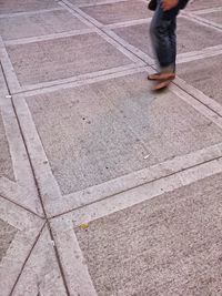 Low section of woman standing on tiled floor