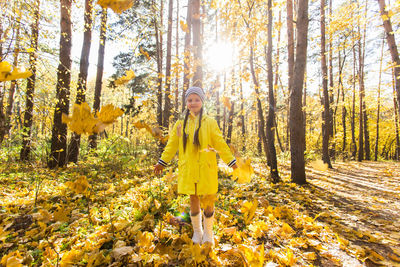 Woman standing in forest during autumn