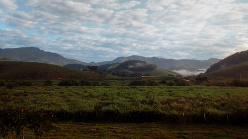 Scenic view of mountains against cloudy sky