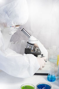 Research scientist using a microscope in a laboratory, concept science and technology.