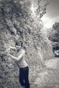 Full length of woman standing by tree