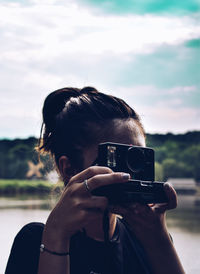 Portrait of woman photographing