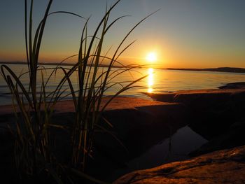 Scenic view of sea against romantic sky at sunset