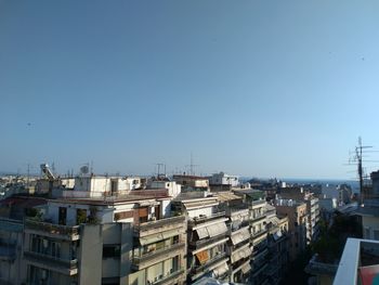 High angle view of buildings against clear blue sky