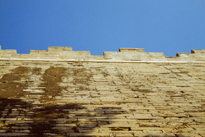 Low angle view of built structure against clear blue sky