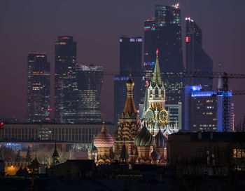 St basils cathedral and spasskaya tower in illuminated city against sky at night