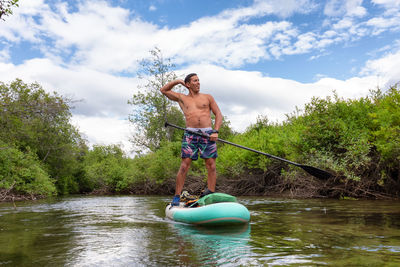 Full length of shirtless man in water