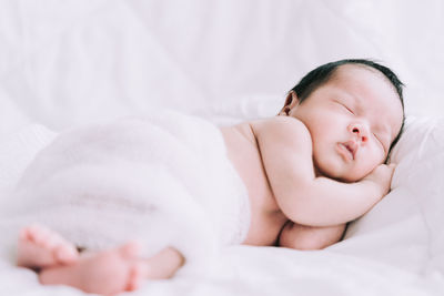 Cute baby sleeping on bed