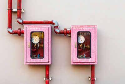 Close-up of telephone booth against wall