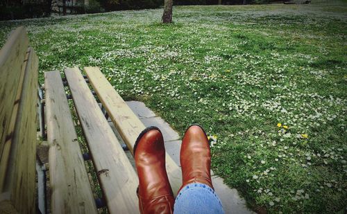 Low section of person standing on grassy field