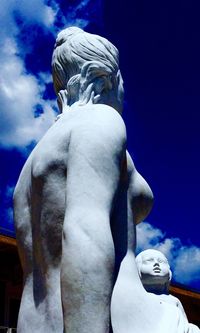 Low angle view of statue against blue sky