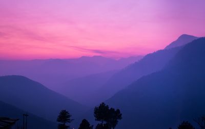 Scenic view of silhouette mountains against sky at sunset