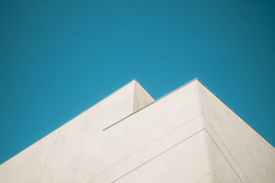 Low angle view of building against clear blue sky