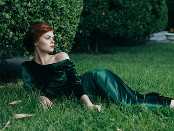 Young woman on grass in field