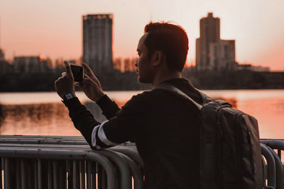 Man photographing at sunset