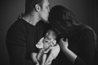 Midsection of mother holding baby