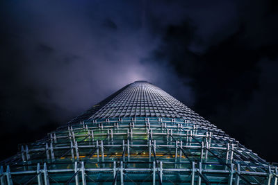 Low angle view of illuminated building against sky at night