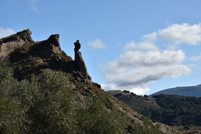 Low angle view of rock formation against sky