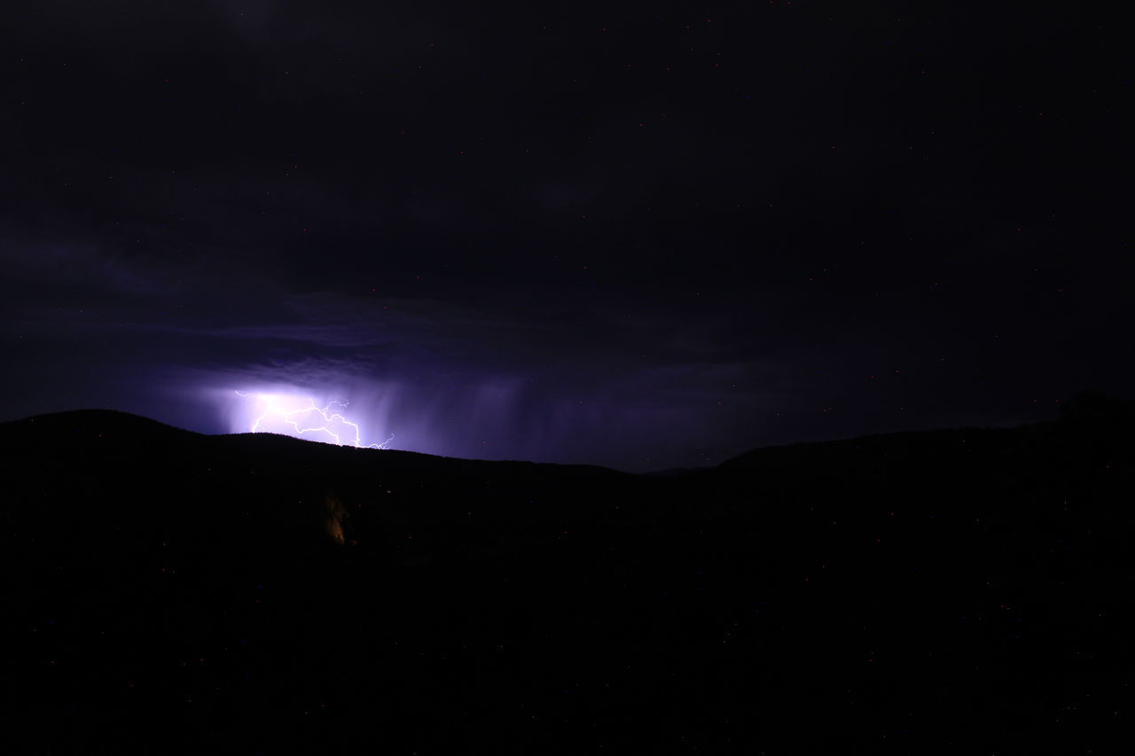night, darkness, sky, beauty in nature, mountain, scenics - nature, cloud, environment, power in nature, lightning, silhouette, star, no people, nature, dark, landscape, storm, dramatic sky, space, thunderstorm, light, astronomy, outdoors, moonlight, mountain range, awe