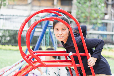 Portrait of smiling woman standing on red outdoors