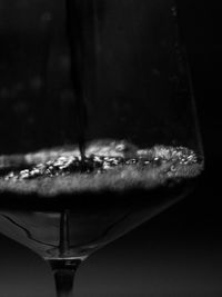 Close-up of beer in glass against black background