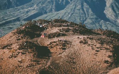 High angle view of people on savanna against mountains