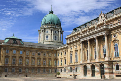 Low angle view of historical building against cloudy sky