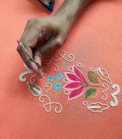 Midsection of woman holding red art