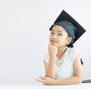 Portrait of a smiling girl over white background