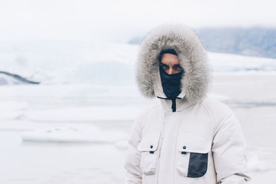 Full length of man standing in snow