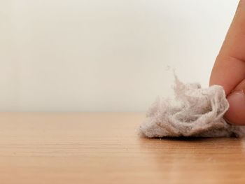 Low section of woman with wool on table