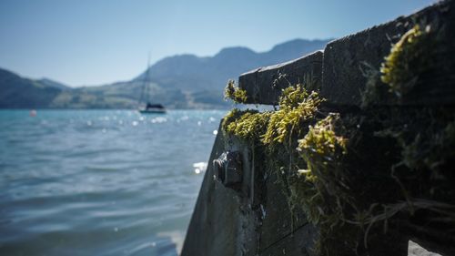 Scenic view of sea and mountains against sky