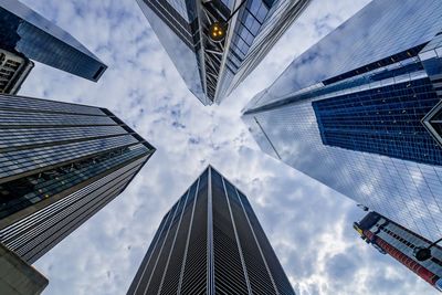 Low angle view of buildings against cloudy sky