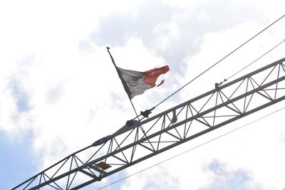 Low angle view of flags against sky