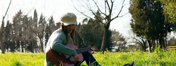Full length of young woman on field