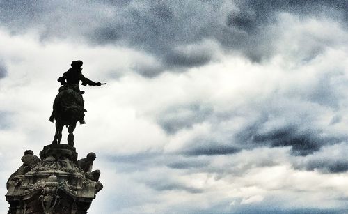 Low angle view of statue against cloudy sky