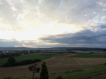 Scenic view of field against cloudy sky