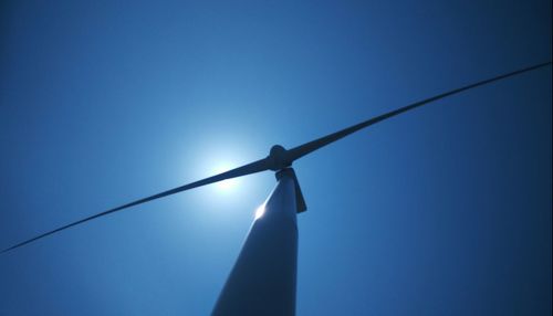 Low angle view of sun against blue sky