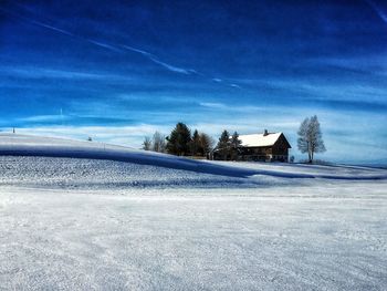 Frozen landscape against blue sky
