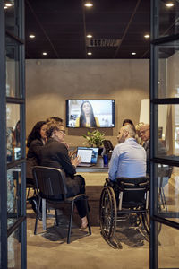 Businessmen and businesswomen discussing during video conference in board room at office