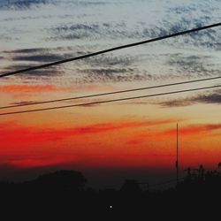 Silhouette of power lines at sunset