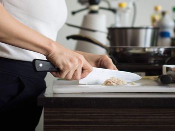 Midsection of woman preparing food at home