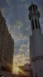 Low angle view of building against cloudy sky