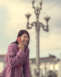 Young woman using mobile phone outdoors