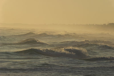 Scenic view of sea against clear sky during sunset