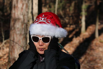 Portrait of woman wearing hat in forest