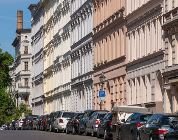 Traffic on road amidst buildings in city