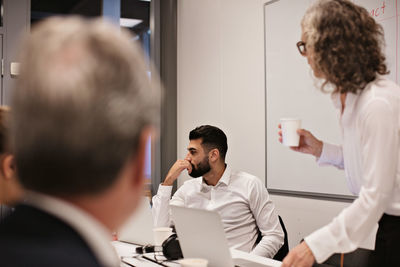 Business professionals discussing in meeting at board room